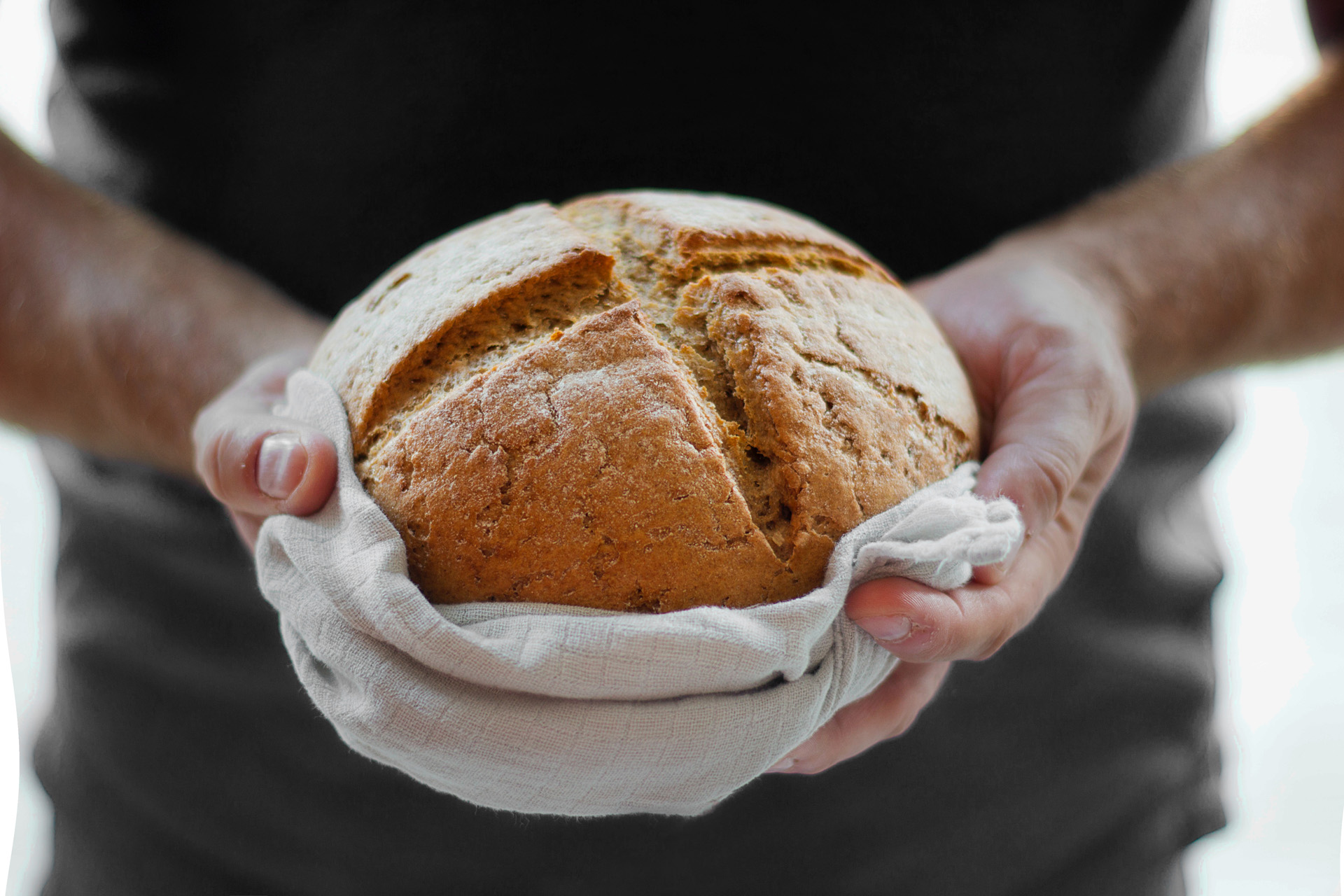 Image of hands holding out bread